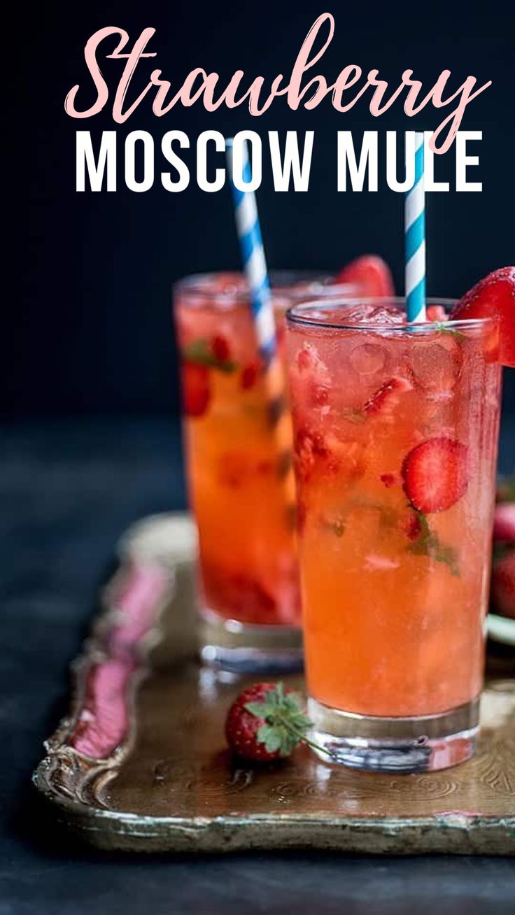 strawberry moscow mules on a tray with strawberries