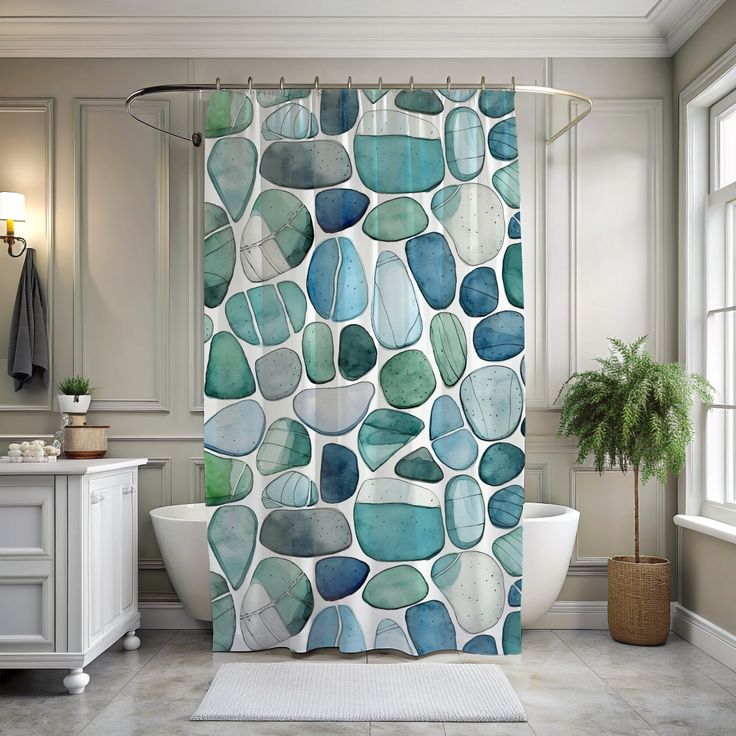 a bathroom with a bathtub, rug and shower curtain in blue and green colors