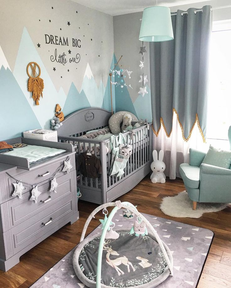 a baby's room decorated in blue and gray