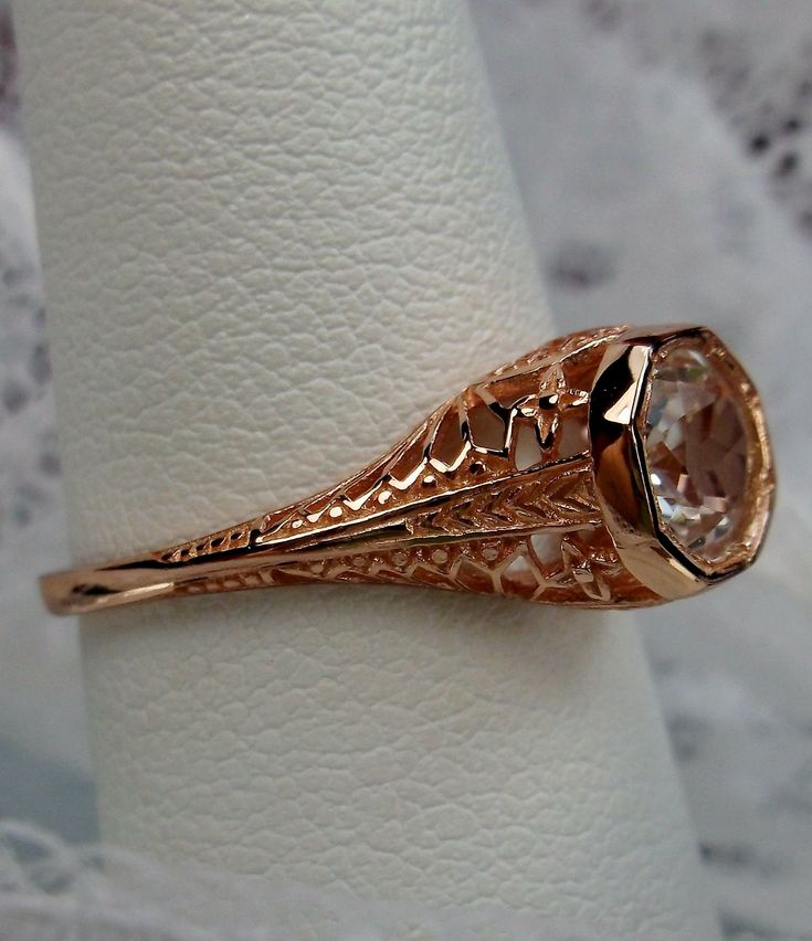 Natural White Topaz Ring Dandelion Design#205 Custom This is a stunning Edwardian wedding reproduction gemstone filigree ring. The approximate 1ct natural white topaz gemstone is 6mm in diameter. This lovely ring is 10K Rose Gold is marked 10K on the inner shank. Notice the beautiful craftsmanship of the rose gold filigree setting. This is an ornate and detailed ring. This is a lovely rendition of an Antique filigree wedding ring, and it is ready to wear. A ring gift box is included and all ring Wedding Filigree Ring With Intricate Design In 14k Gold, Elegant Ceremonial Rings With Filigree Details, Elegant Filigree Rings For Ceremonial Occasions, Elegant Ceremonial Rings With Filigree, Elegant Ceremonial Filigree Rings, Elegant Topaz Ring With Prong Setting For Wedding, Elegant Topaz Wedding Ring With Prong Setting, Elegant Wedding Topaz Ring With Prong Setting, Rose Gold Filigree Wedding Jewelry