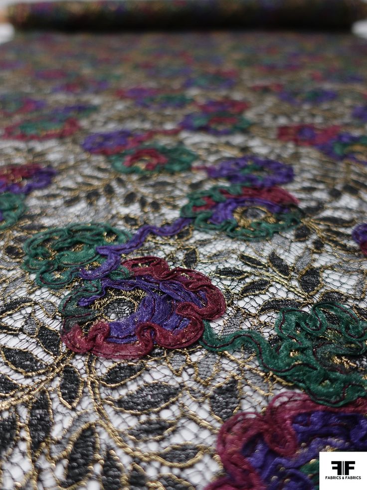 an intricately designed table cloth with colorful flowers on the top and bottom, is shown