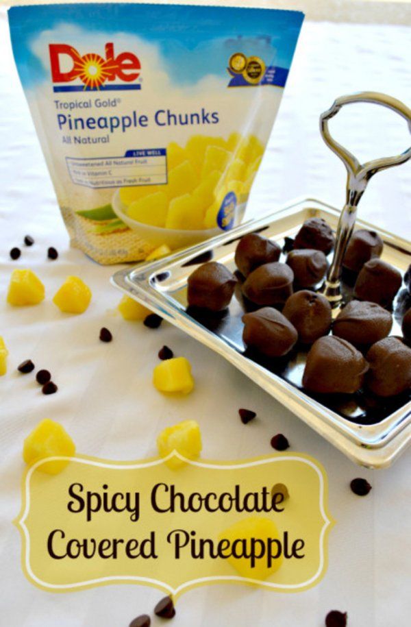 chocolate covered pineapples on a tray with a bag of pineapple chunks in the background