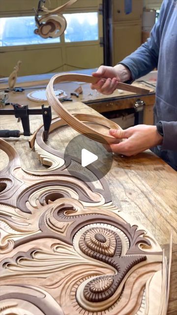 a man is working on some wood carvings