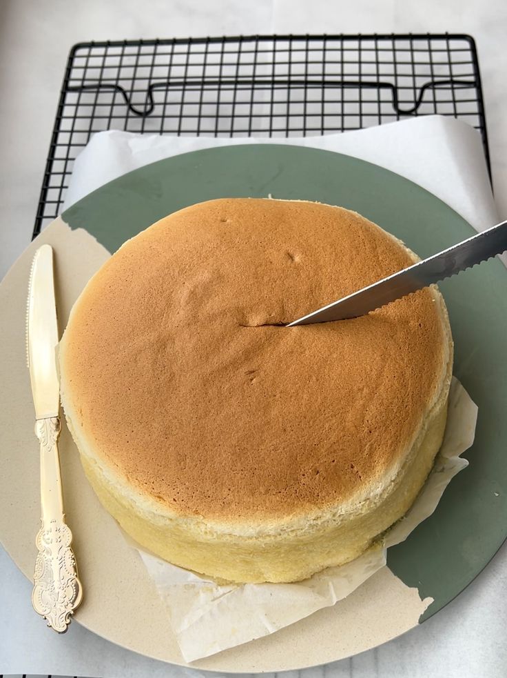 a cake on a plate with a knife sticking out of it's center piece