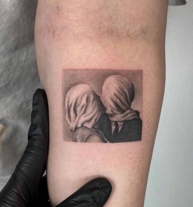 a tattoo on the arm of a woman with two heads covering her eyes and nose