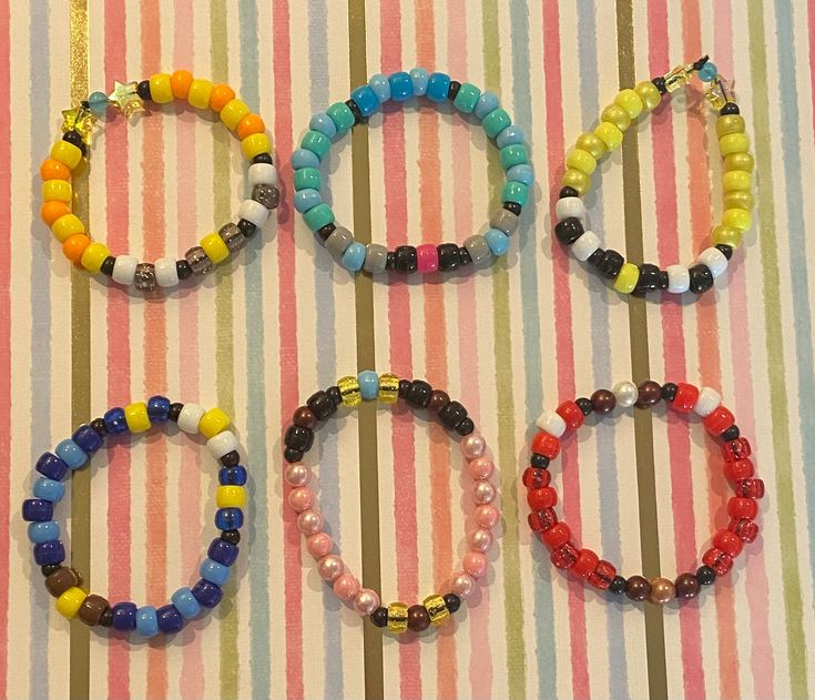 four bracelets are arranged on a striped surface