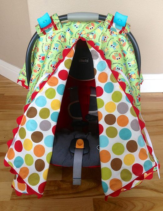 a child's car seat cover with colorful polka dots on the front and sides