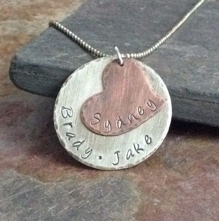 Personalized sterling silver keepsake jewelry is simple enough for everyday wear. This custom necklace is a perfect gift for Grandma, Mom or Daughter on her Birthday, for Christmas or Mother's Day. *Personalized with Names *Handcrafted from sheet metal *Antiqued finish .925 Sterling Silver and Copper with Blackened Letters *Boxed in simple kraft cotton filled box with ribbon bow *Polishing cloth included with all orders *Handmade when ordered prior to shipping, please see storefront for producti Sterling Silver Charm Necklace For Valentine's Day Keepsake, Sterling Silver Nickel-free Heart Necklace Keepsake, Sterling Silver Nickel-free Heart Necklace For Keepsake, Nickel Free Double Heart Jewelry For Anniversary, Stamped Sterling Silver Jewelry For Valentine's Day, Hand Stamped Sterling Silver Heart Necklace For Anniversary, Hand-stamped Sterling Silver Heart Pendant Necklace, Sterling Silver Hand Stamped Heart Necklace, Hand Stamped Sterling Silver Heart Pendant Necklace