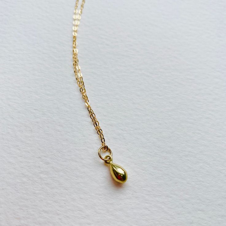 Solid 9ct Yellow Dainty Teardrop Pendant Necklace - handmade - Bohemian style necklace Beautifully simple teardrop pendant on a diamond cut solid gold necklace. This piece is handcrafted and finished in my studio. Pendant - Made with solid 9ct gold, approximately 7mm diameter polished finish. Brushed finish also available. Necklace - Made in solid 9ct gold diamond cut necklace (polished) There are two chain options Both finished necklaces shown are solid 9ct gold: The necklace shown in the first Gold Drop Necklaces In 14k Gold, Dainty Yellow Gold Drop Necklace For Everyday, Classic Teardrop Drop Necklace Gift, 14k Gold Teardrop Necklace With Delicate Chain, Dainty 14k Gold Teardrop Pendant Necklace, Dainty Yellow Gold Drop Necklace As Gift, Minimalist Briolette Drop Necklace For Gift, Minimalist Drop Necklace For Gift, Gold Sterling Silver Teardrop Pendant Necklace