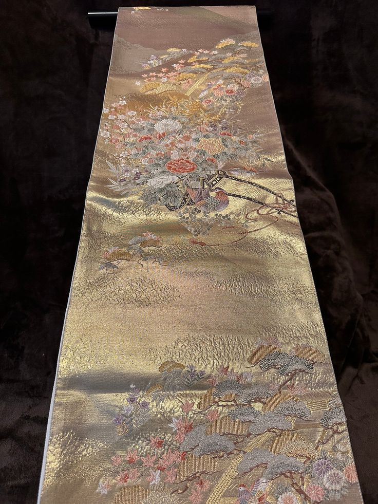 Free shipping Vintage Japanese Obi (Kimono sash), 100%silk, Shinning Gold base, High-density Embroidery 05-0014 On this Obi, the colors are tender, yet it looks gorgeous with tenderly shining gold.   The atmosphere of this Obi is gorgeous but at the same time calm because we don't feel self-assertive from this Obi.  Please appreciate Japanese elegance and chicness having this obi in your hands. We offer a set of a hanger and a pair of weights for Obi hanging decoration for a set price.  Please see below for ** Set of Obi Decoration Hunger and Weights, and item No.03-0100 for photos of the set.        Fukuro-Obi (One side pattern) Rokutsu- Gara ( Main pattern on approximately 60% of the front side ) Back side (another silk fabric) - ivory plain Appro.40% of front side - ivory plain width 30 Traditional Silk Scarf For Formal Occasions, Traditional Formal Silk Scarf, Traditional Gold Ceremonial Kimono, Elegant Gold Kimono For Ceremonial Occasions, Japanese Elegance, Obi One, Obi Kimono, Belt Kimono, Japanese Obi