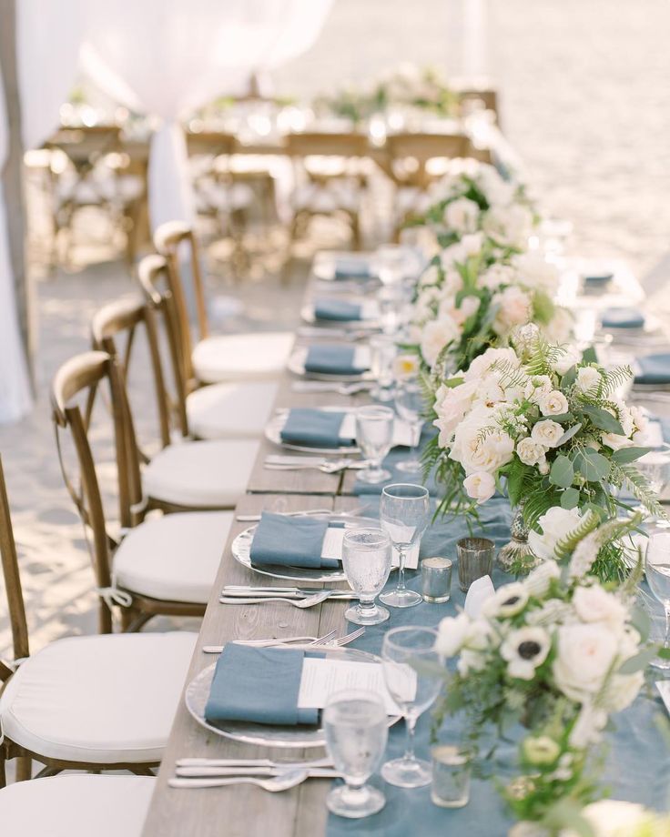 a long table is set with blue and white linens