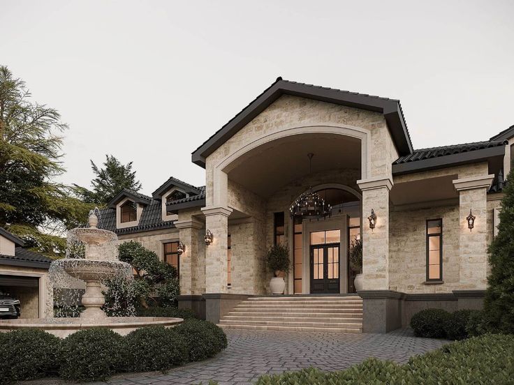 the front entrance to a large home with stone steps leading up to it's entry