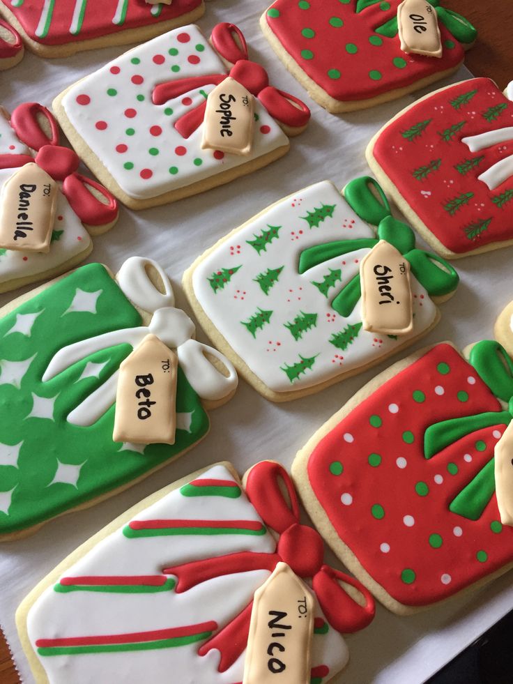 decorated christmas cookies are displayed on a table