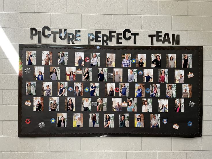 a group of people standing next to each other in front of a black board with pictures on it