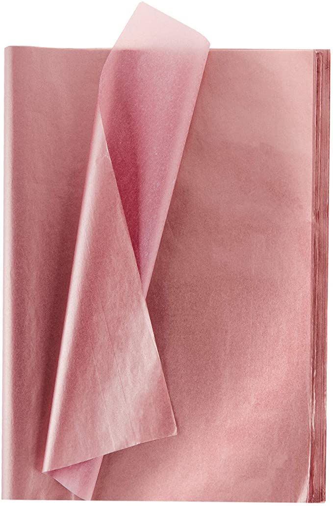 pink sheets folded on top of each other in front of a white background with red edges