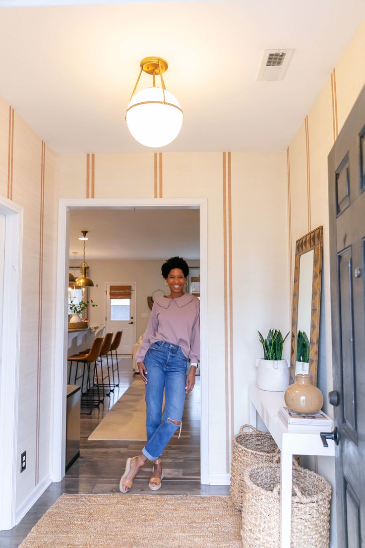 a woman standing in the doorway of a house