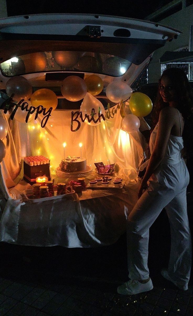 a woman standing in front of a birthday cake