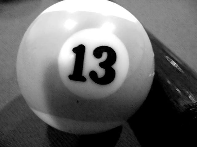 a white pool ball with the number thirteen on it