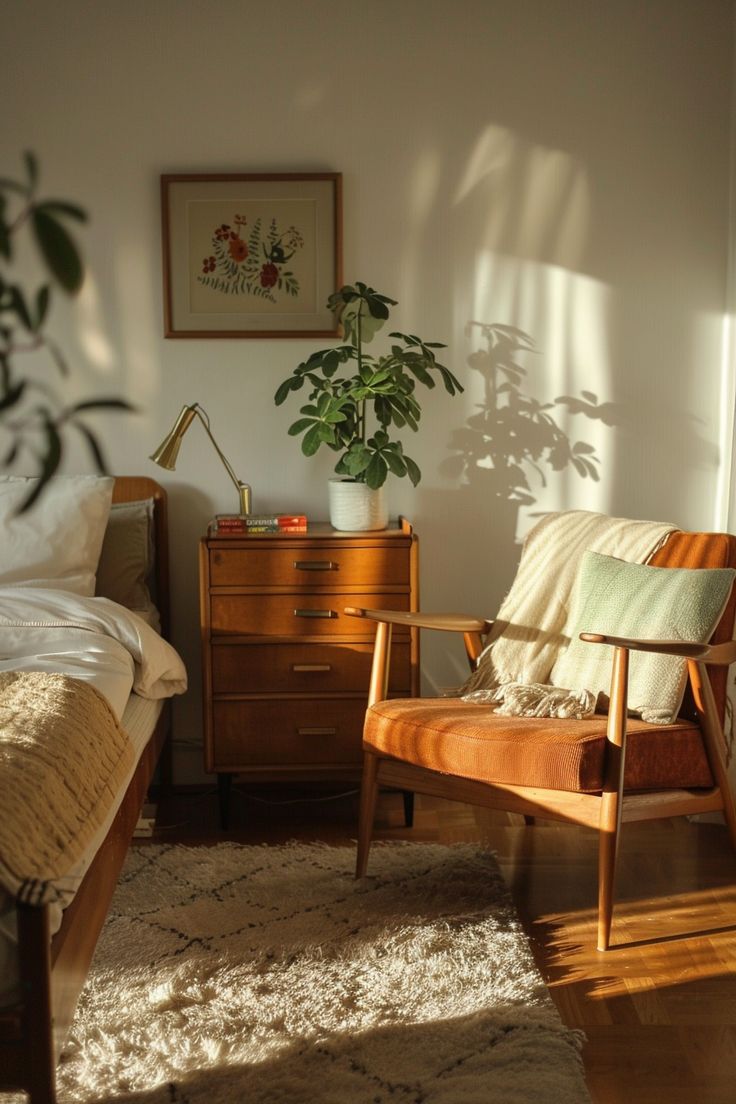 a bed room with a neatly made bed next to a dresser and a plant in the corner