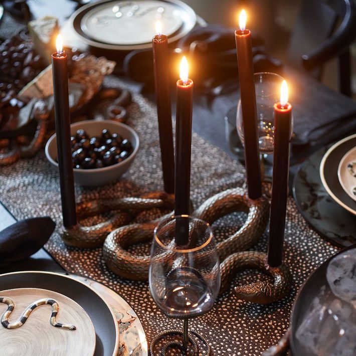 a table topped with candles and plates filled with food