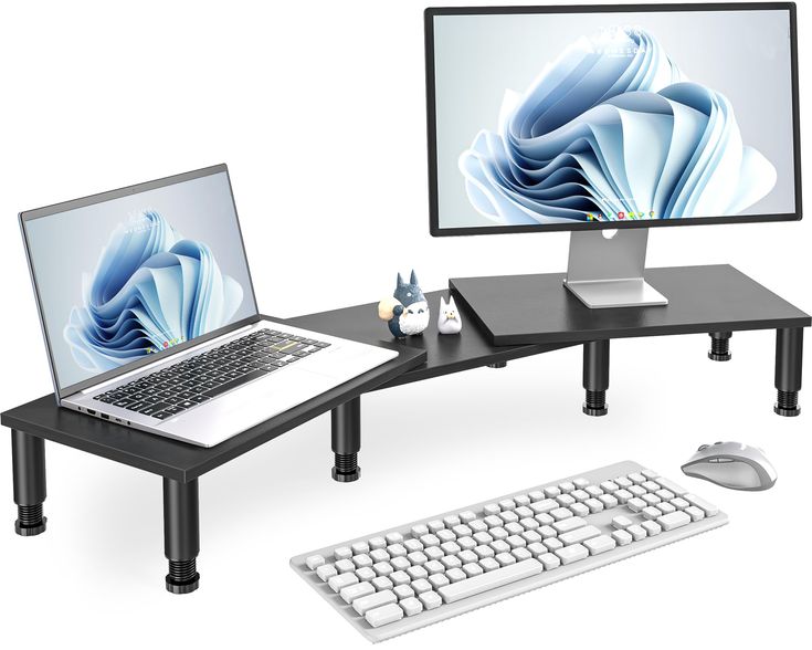 a computer desk with two monitors and a laptop on it, along with a keyboard and mouse