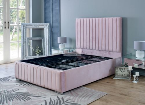 a bedroom with blue walls, pink bedding and mirrored furniture on the floor in front of a large window