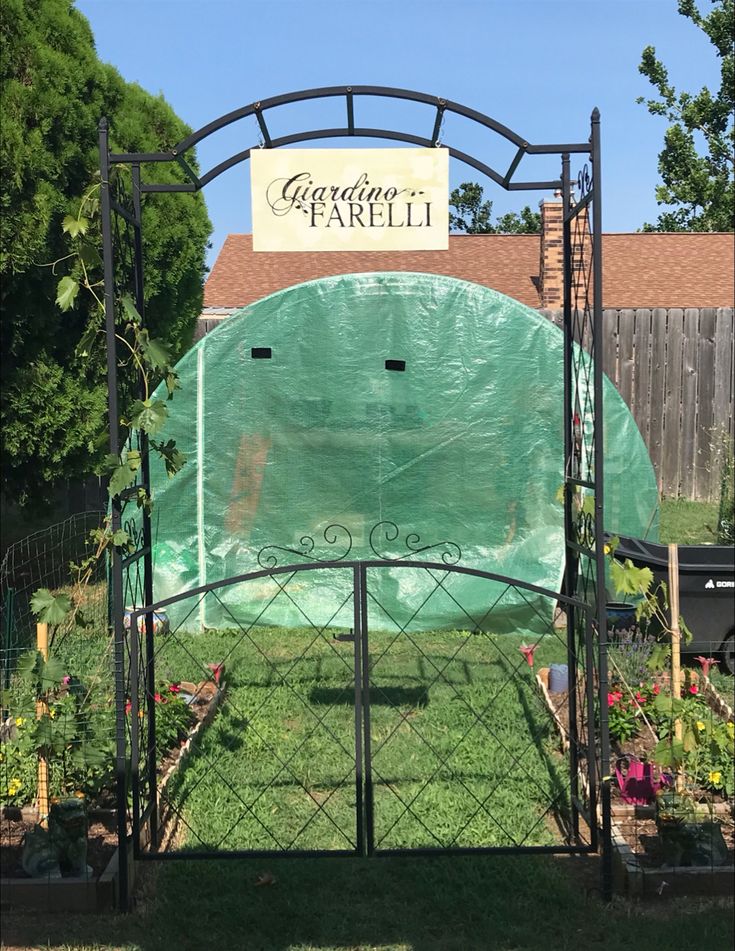 a garden area with a green cover over it