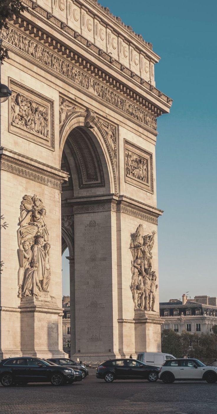 cars are parked in front of the arc de trio triumphe, which is also known as the arch of triumph