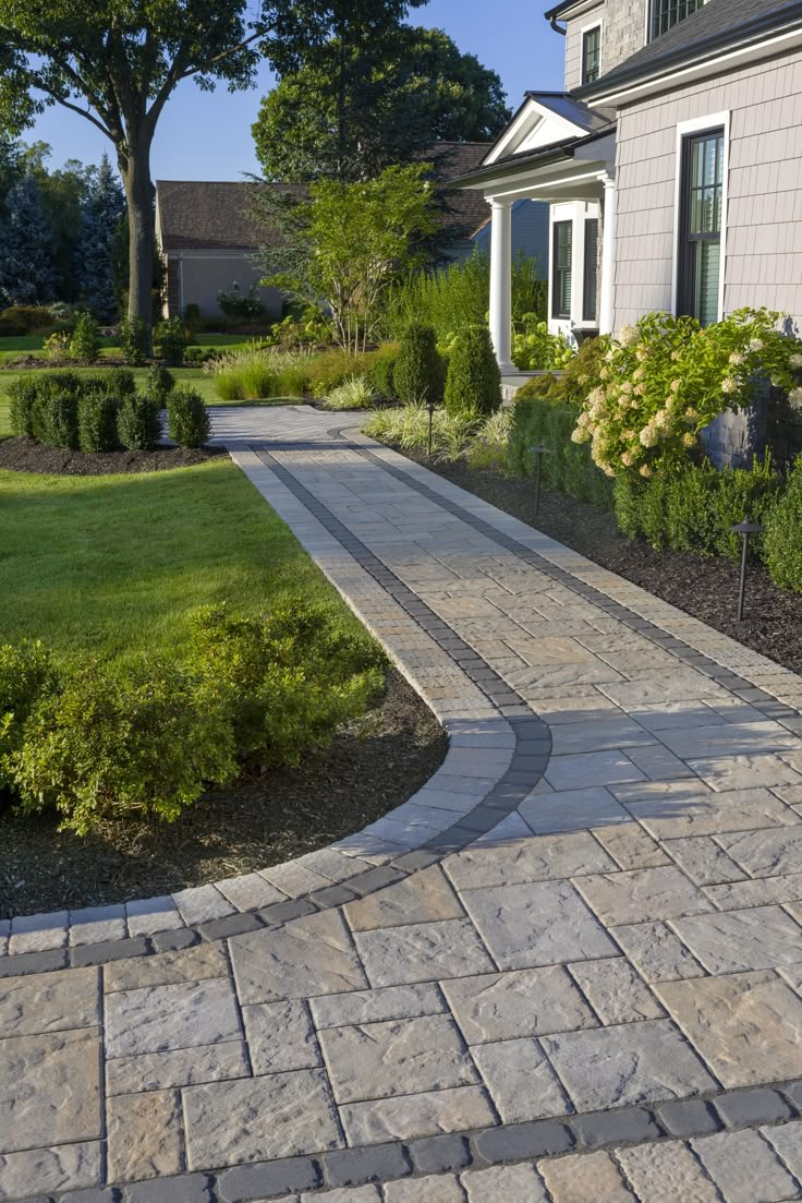 a stone walkway in front of a house