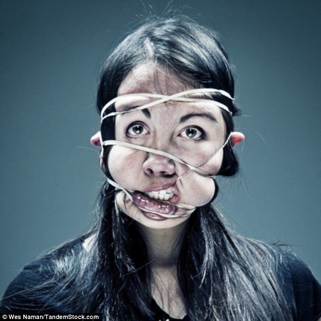 a woman with duct tape on her face and mouth in front of her head, looking surprised at the camera