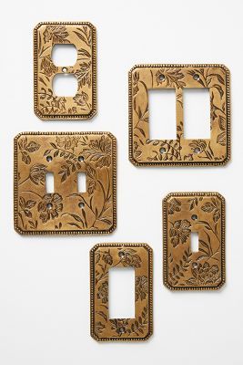 four wooden switch plates with floral designs on them