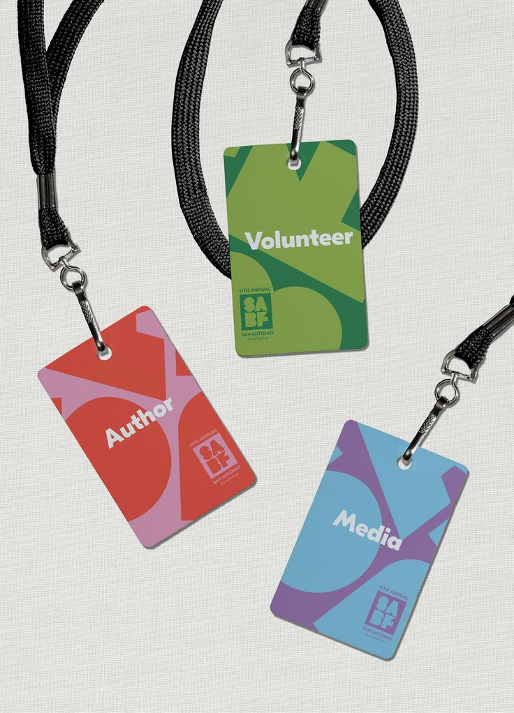 three lanyards with name tags attached to them on a black cord and white background