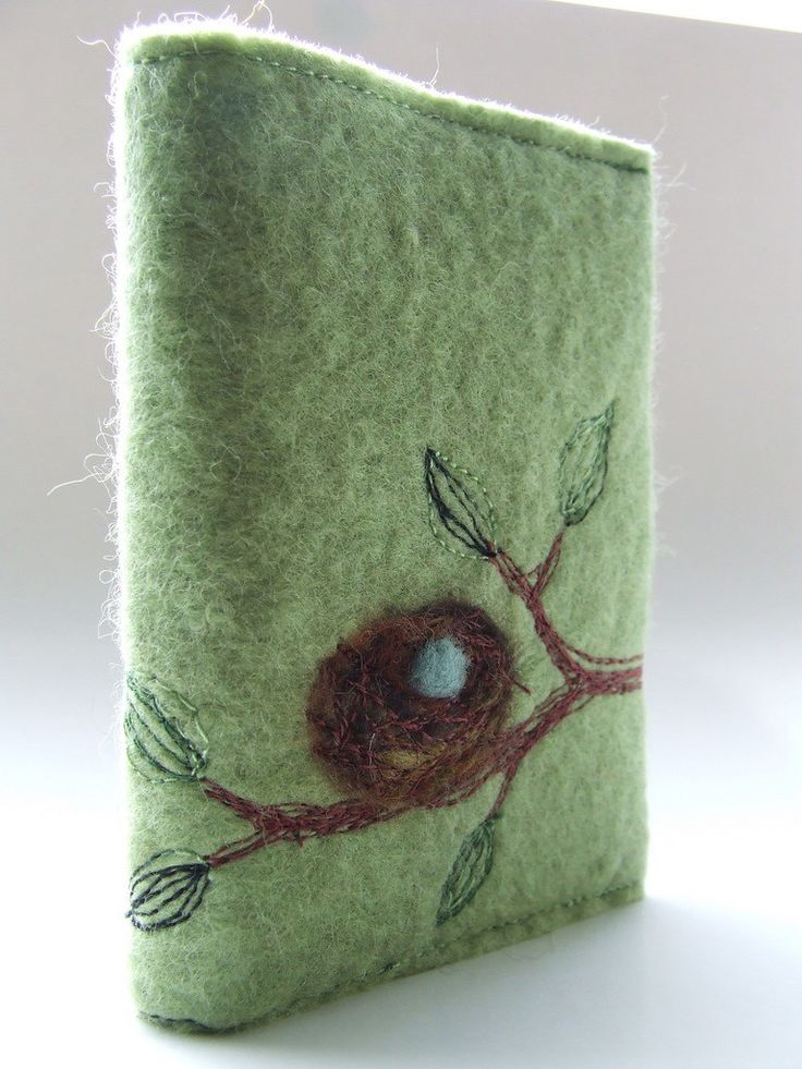 a small felt book with a bird's nest on it