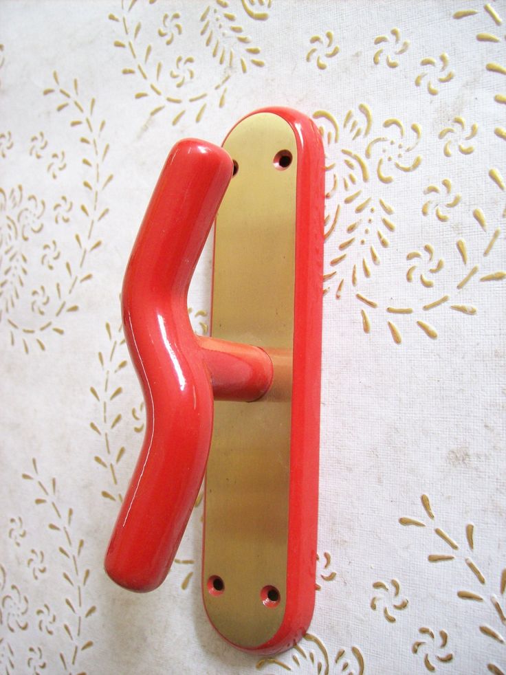 a red and gold door handle on a white tablecloth