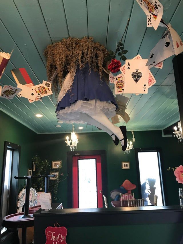 a room with cards hanging from the ceiling and decorations on the ceiling above it,