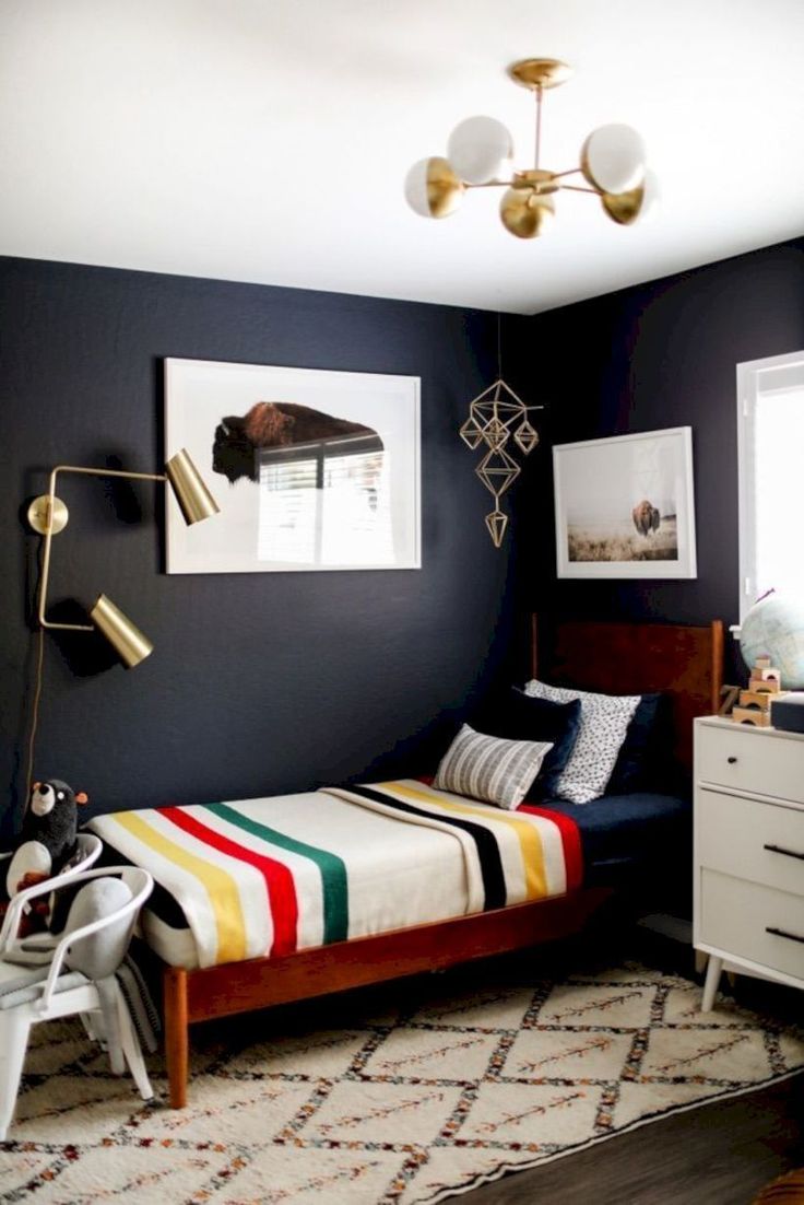 a bedroom with a bed, dresser and two pictures on the wall above it that are hanging