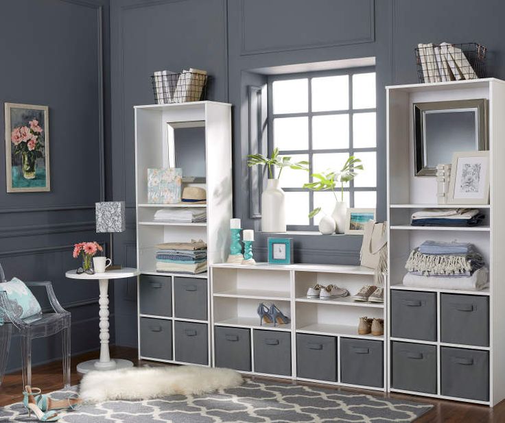 a white bookcase with gray drawers and shelves on the wall next to a window that says, buy one get one 50 % off all system build cube storage