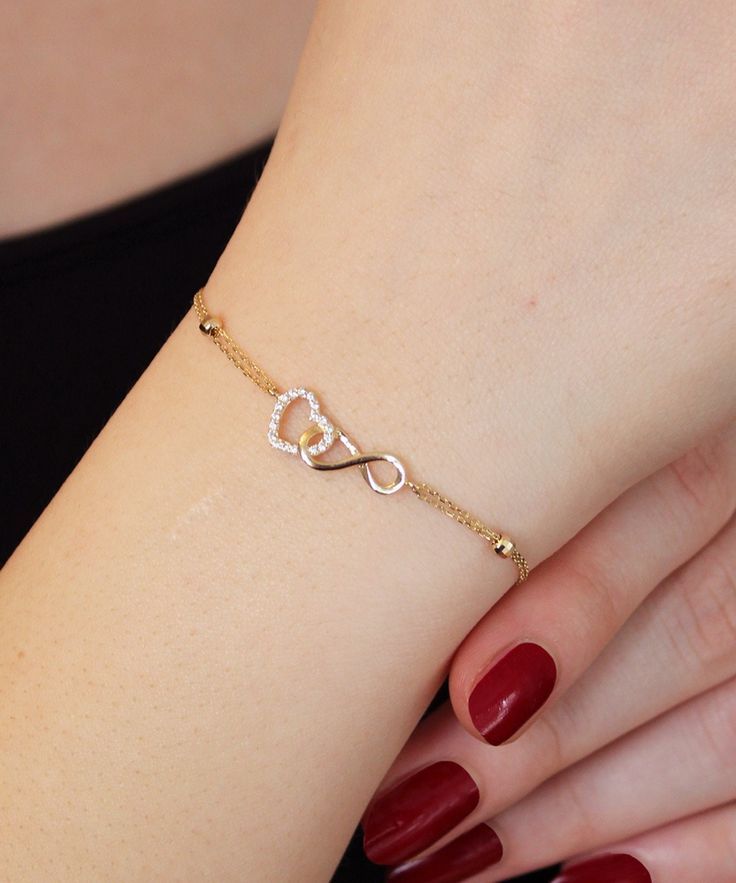 14K Gold Heart and Infinity Symbol Bracelet A symbol of infinite love, this elegant bangle bracelet showcases the symbols of love and eternity entwined with each other. The heart motif perfectly complements the infinity symbol for a truly romantic look. This unique bracelet is perfect for everyday wear as it is made of solid gold and won't tarnish. It is a wonderful gift for a special person. Features: * This bracelet is made of patented 14K solid gold. * It has a 16cm chain and 2cm charm Gold Unique Bracelet For Women, Heart And Infinity Necklace, Infinity Heart Bracelet, Gold Heart Bracelet For Women, Women’s Bracelets Gold, Beautiful Bracelet Gold, A Bracelet Gold, Chain Bracelet Designs Gold For Women, Bracelet Design For Girls In Gold