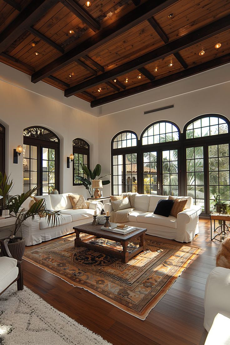 a living room filled with white furniture and lots of windows on top of each other