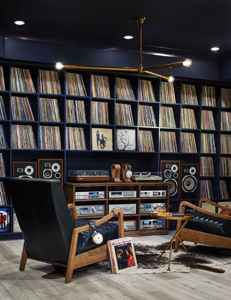 a room filled with lots of books and audio equipment