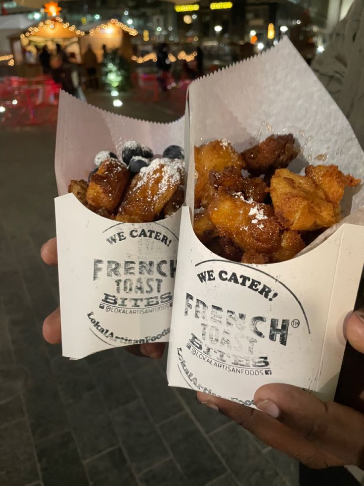 two people holding up some very tasty looking food in their hands and one has blueberries on it