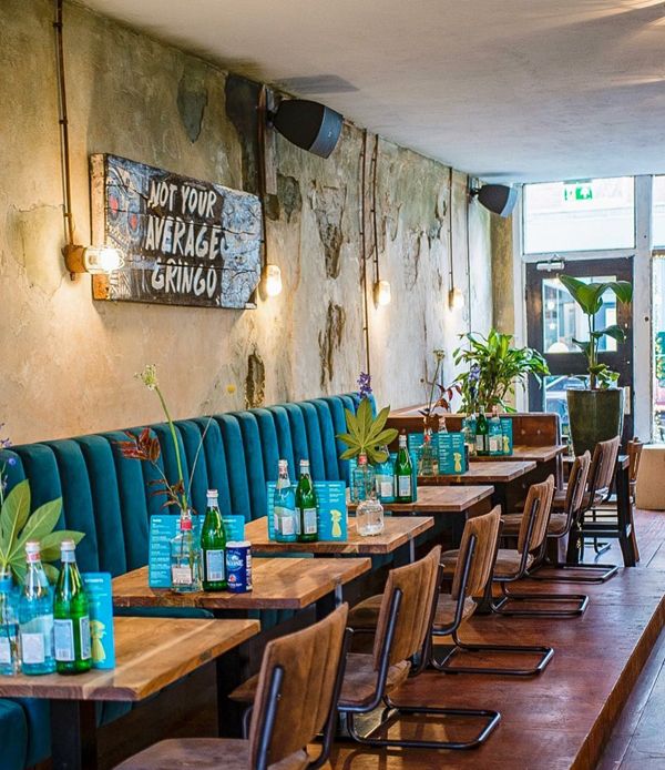 a restaurant with blue chairs and wooden tables