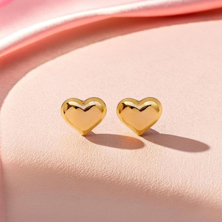 Our mini heart-shaped stud earrings, crafted in 14K gold, are the epitome of elegance in a small, delicate design. These lightweight studs bring a subtle yet luxurious charm, making them an ideal everyday accessory or an exquisite addition to a special occasion. Thoughtfully designed, they make a perfect birthday gift for her, symbolizing love and grace. Trending now for their timeless appeal and fine craftsmanship, these earrings are a popular choice among modern jewelry lovers. Yellow Gold Heart Earrings For Anniversary And Mother's Day, Yellow Gold Heart Earrings For Mother's Day Anniversary, Yellow Gold Heart Earrings For Anniversary On Mother's Day, Valentine's Day Yellow Gold Heart Earrings For Pierced Ears, Dainty Gold Earrings For Valentine's Day, Gold Dainty Earrings For Valentine's Day, Yellow Gold Double Heart Earrings For Valentine's Day, Gold Heart Cut Earrings Gift For Her, Gold Heart Cut Earrings As A Gift For Her