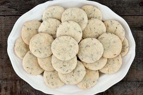 a white bowl filled with cookies on top of a wooden table