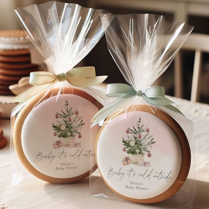 two cookies wrapped in cellophane and tied with bows are sitting on a table