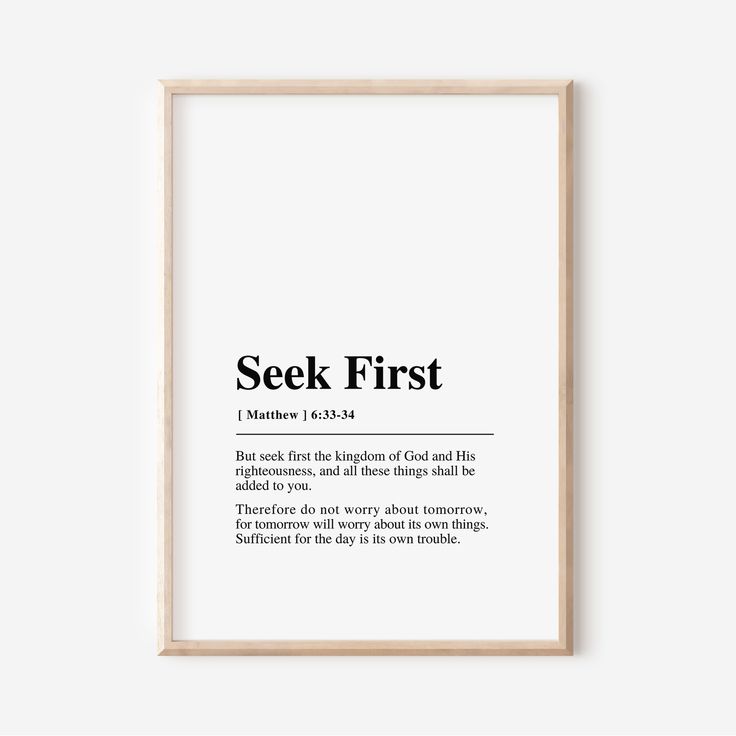 a framed print with the words seek first in black and white, on a wall