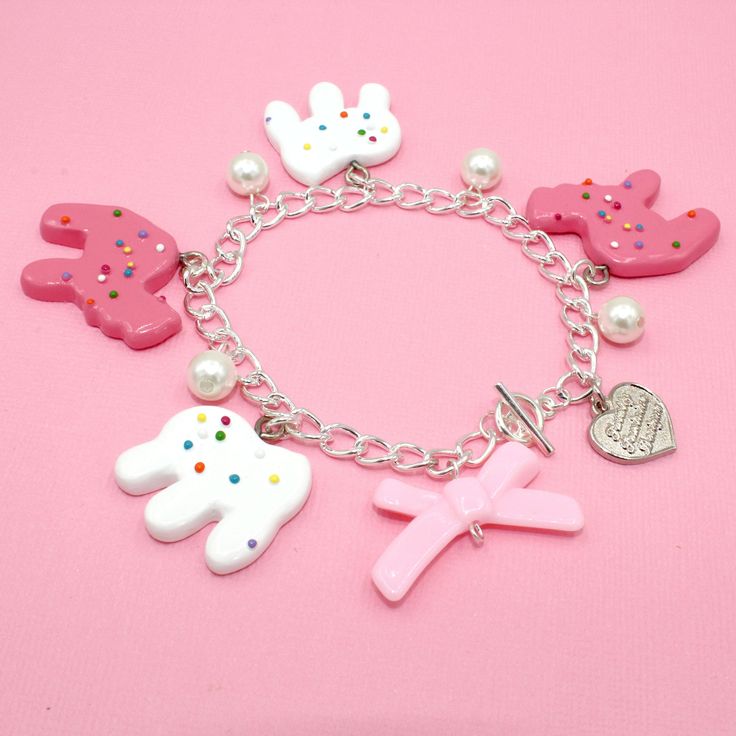 This frosted circus animal cookie bracelet is so whimsical, girly and fun, a perfect gift for any woman who loves cute charm jewelry, kawaii or pink. Handmade, the resin pendants are so realistic you may think they are real cookies! The cookie charms are on the larger side so this is definitely a statement piece. Available in your choice of gold or Silver finish.Details & Measurements: Pendants are hand-painted resin Pendants are 1.5" in size (3.75cm) Bracelet is 7.5" long (18.75 cm) Available in gold or silver finish Glass Pearls Baby Pink Bow Bead Finished with a Fatally Feminine Designs heart charm and toggle clasp Handmade More Animal Cookie Jewelry available, just search "animal Cookie"Shipping & Gift Options: item is handmade to order and will take around 1 week to process before shi Cute Nickel-free Charm Bracelet For Friendship, Pink Kawaii Jewelry For Valentine's Day, Kawaii Pink Jewelry For Valentine's Day, Playful Charms Jewelry For Birthday, Personalized Pink Novelty Charm Bracelet, Playful Dangle Personalized Jewelry, Pink Charms Bracelets Novelty Style, Pink Novelty Bracelets With Charms, Playful Pink Jewelry With Removable Charms