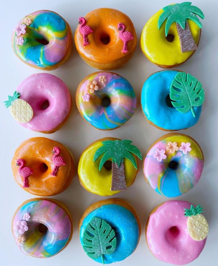 the donuts are decorated with different types of frosting and palm tree decorations on them