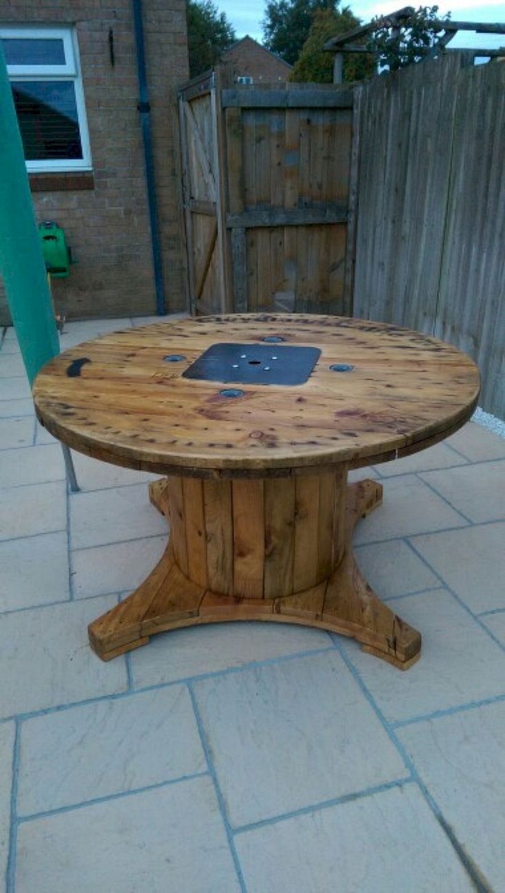 a wooden table sitting on top of a patio