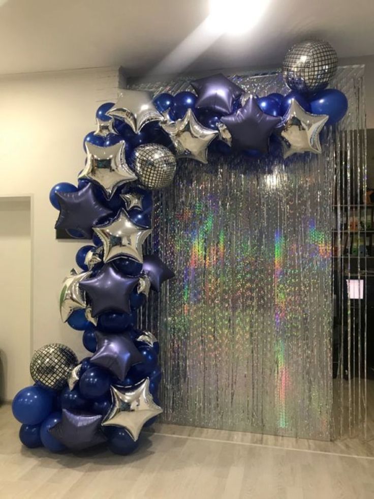 blue and silver balloons are arranged in the shape of stars